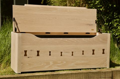 Whitewashed white-oak storage chest with
        charred handle